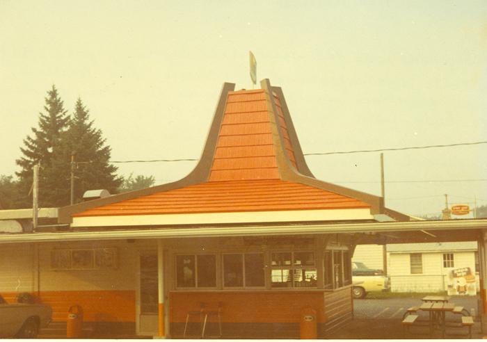 Vintage fast food restaurant building with a tall orange roof structure