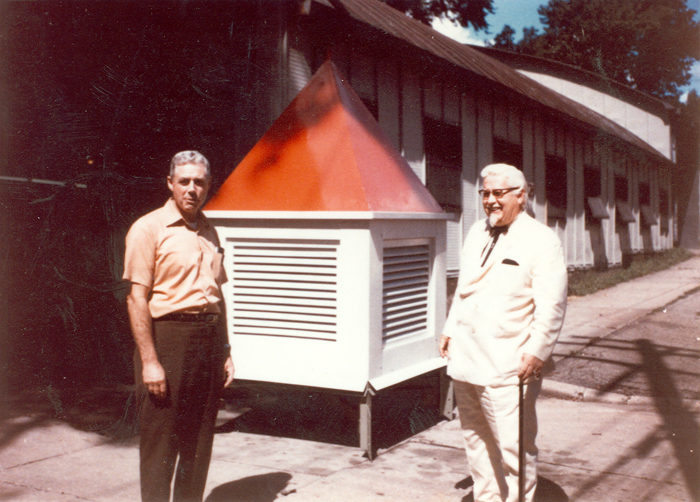 Paul Lindau standing beside a rooftop ventilation structure