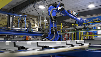 Industrial robotic arm assembling metal components on an manufacturing line